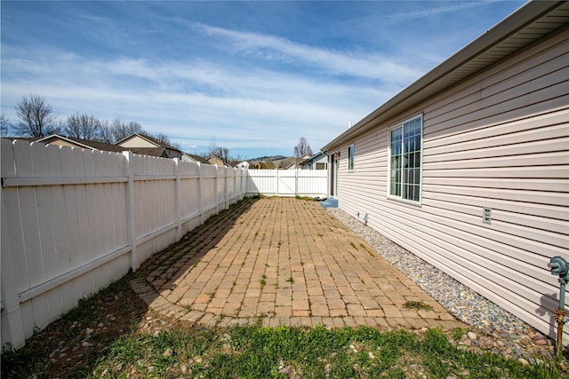 view of yard featuring a patio and a fenced backyard