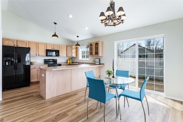 kitchen with light wood-style flooring, a peninsula, light brown cabinetry, and black appliances