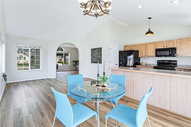 dining room with baseboards, arched walkways, an inviting chandelier, recessed lighting, and light wood-style flooring
