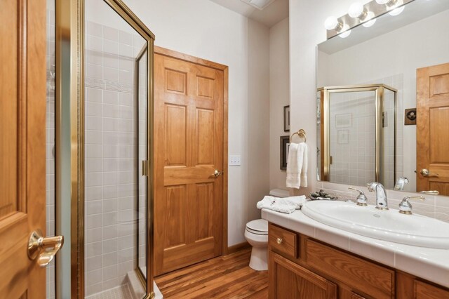 196 Pine Needle Ln, Bigfork, MT 59911 - bathroom featuring vanity, a stall shower, and wood finished floors