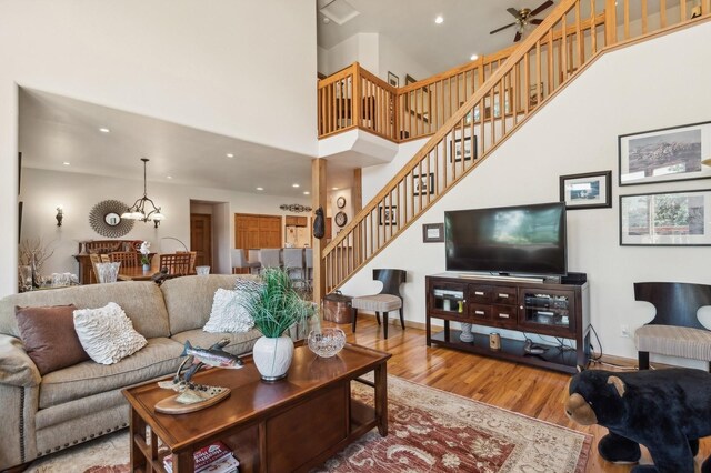 196 Pine Needle Ln, Bigfork, MT 59911 - living area with wood finished floors, a high ceiling, stairway, a ceiling fan, and recessed lighting