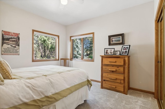 196 Pine Needle Ln, Bigfork, MT 59911 - carpeted bedroom featuring baseboards and a ceiling fan