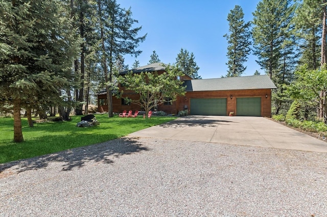 196 Pine Needle Ln, Bigfork, MT 59911 - view of front facade with driveway, an attached garage, and a front yard
