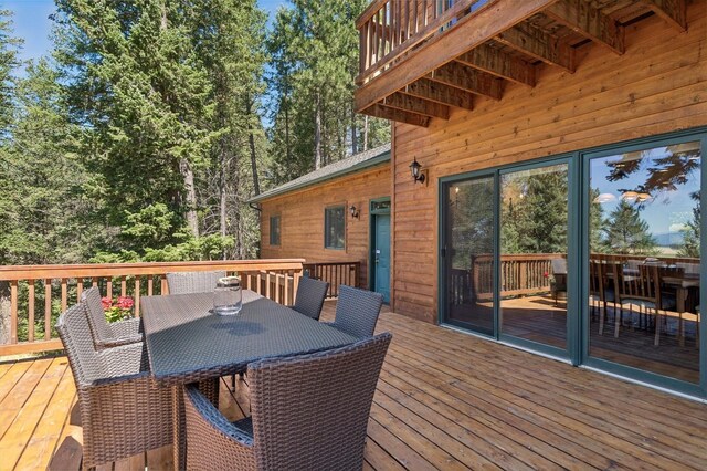 196 Pine Needle Ln, Bigfork, MT 59911 - wooden deck featuring outdoor dining space