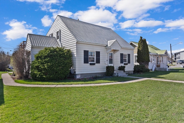 view of front of house with a front yard and metal roof