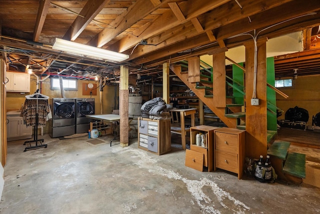 basement featuring washing machine and dryer and stairway