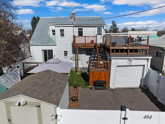 view of front of home with a gate, a fenced front yard, and metal roof
