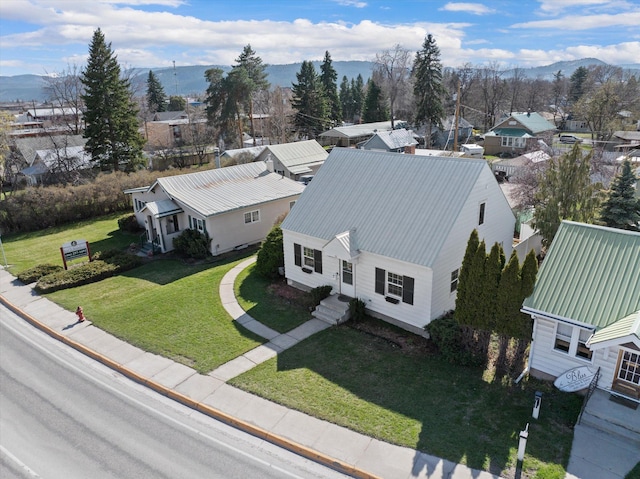 drone / aerial view featuring a residential view and a mountain view