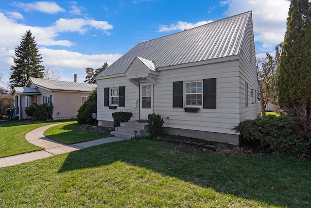 bungalow-style house with a front lawn and metal roof