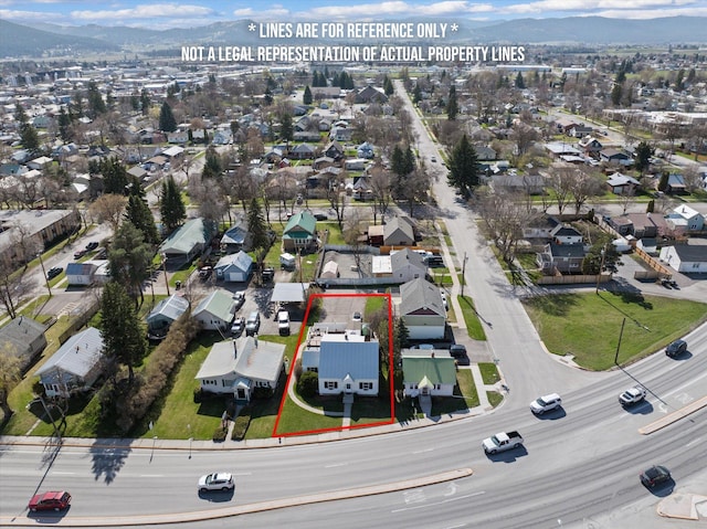 birds eye view of property with a mountain view and a residential view