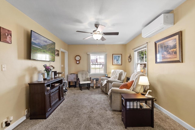 living area featuring ceiling fan, baseboards, carpet floors, and a wall unit AC