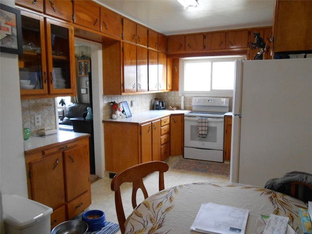 1426 2nd Ave NW, Great Falls, MT 59404 - kitchen featuring white appliances, backsplash, and brown cabinetry