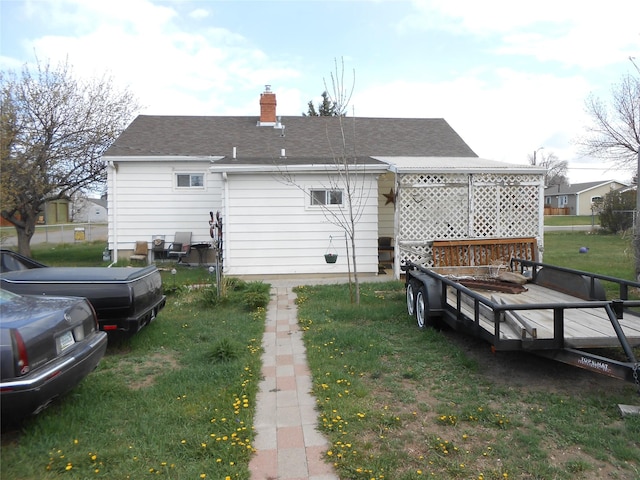 1426 2nd Ave NW, Great Falls, MT 59404 - rear view of house featuring a shingled roof, a yard, and a chimney