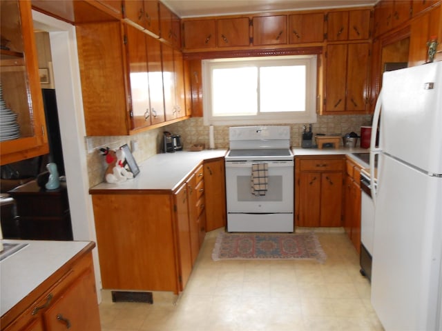 1426 2nd Ave NW, Great Falls, MT 59404 - kitchen with light countertops, brown cabinets, decorative backsplash, and white appliances