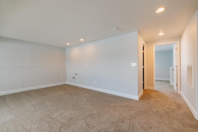 empty room featuring carpet, recessed lighting, baseboards, and a smoke detector