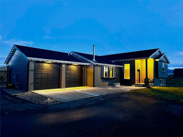 view of front of house featuring an attached garage and driveway