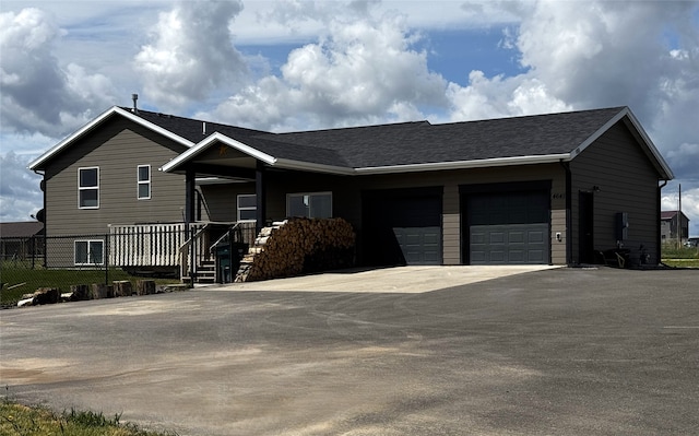 ranch-style home featuring driveway and a garage