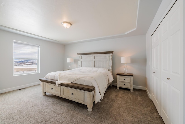 carpeted bedroom with baseboards and a closet
