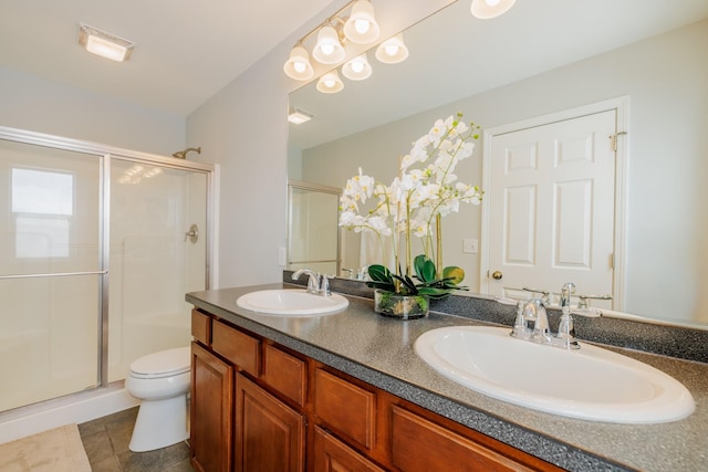 full bathroom with a stall shower, toilet, and double vanity