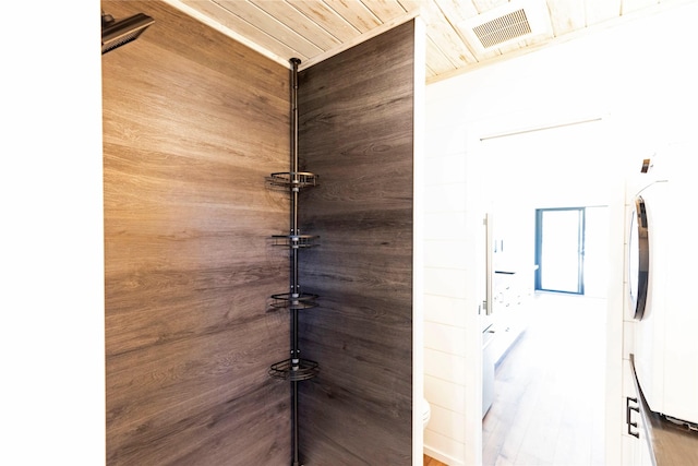 interior details featuring wood ceiling, visible vents, and washer / clothes dryer