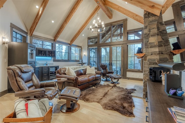 30 Bear Dance Vlg, Bigfork, MT 59911 - living area with high vaulted ceiling, a chandelier, beamed ceiling, plenty of natural light, and wood finished floors