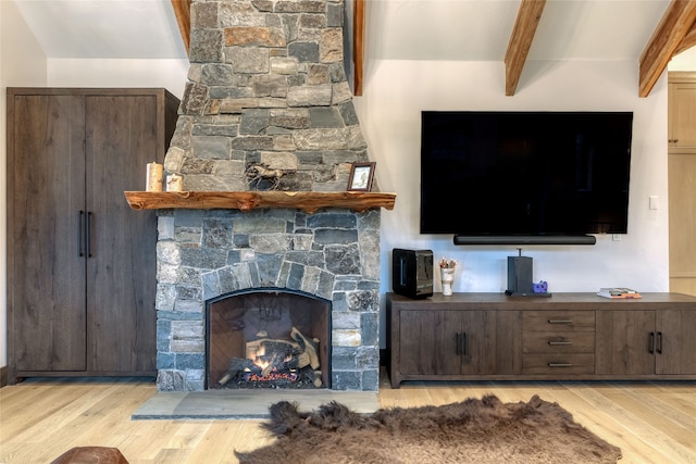 30 Bear Dance Vlg, Bigfork, MT 59911 - living area with light wood-style floors, beamed ceiling, and a stone fireplace
