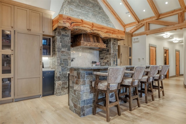 30 Bear Dance Vlg, Bigfork, MT 59911 - indoor wet bar with high vaulted ceiling, light wood-style flooring, decorative backsplash, and beam ceiling