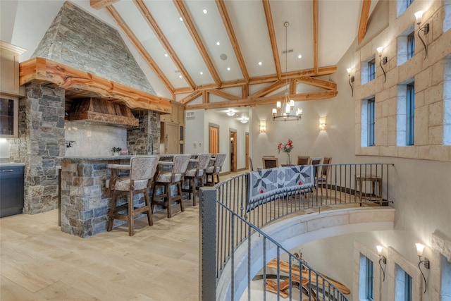 30 Bear Dance Vlg, Bigfork, MT 59911 - stairs featuring high vaulted ceiling, wood finished floors, beam ceiling, a chandelier, and a community bar