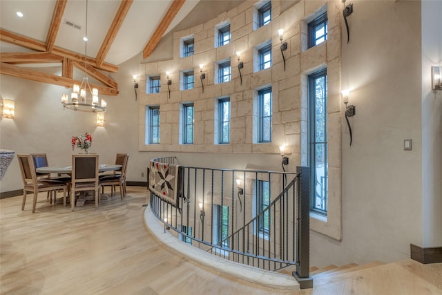 30 Bear Dance Vlg, Bigfork, MT 59911 - hall with high vaulted ceiling, beam ceiling, wood finished floors, and a chandelier