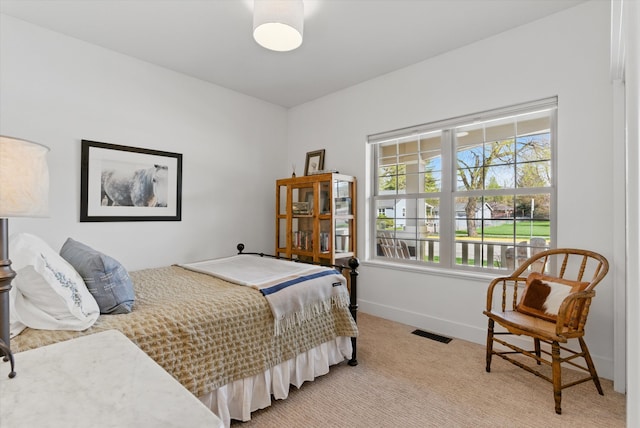 bedroom with light colored carpet, baseboards, and visible vents