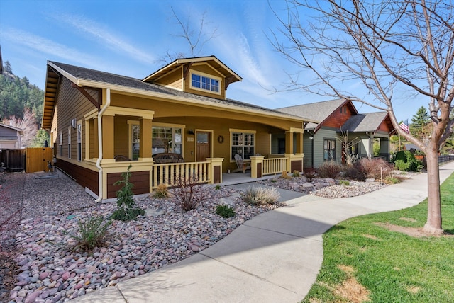 view of front facade with a porch and fence
