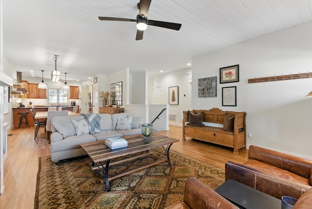 living area featuring a ceiling fan and light wood-style floors