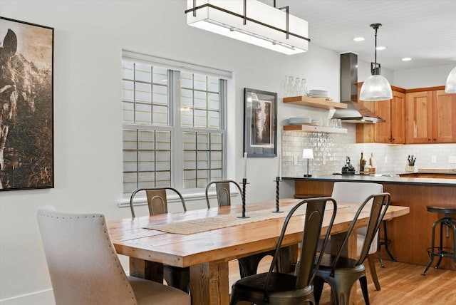 dining space with light wood-style flooring