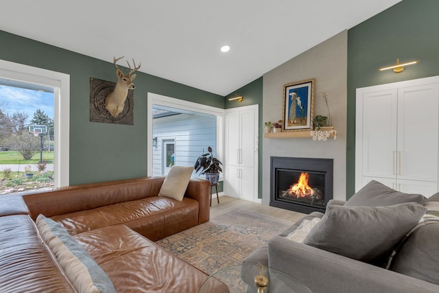living room with recessed lighting, vaulted ceiling, wood finished floors, and a fireplace