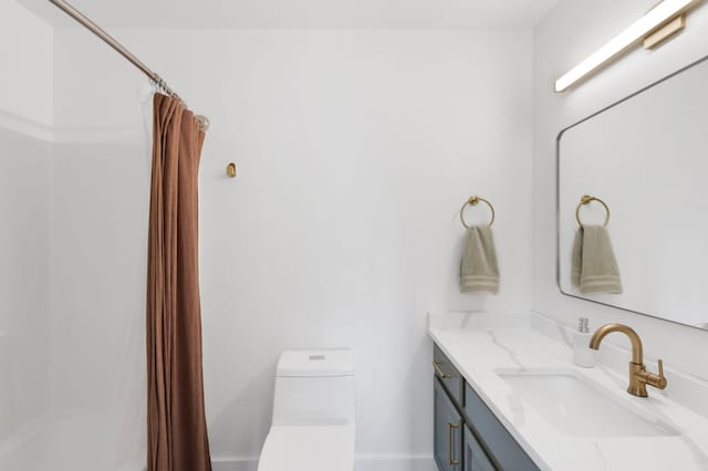 bathroom featuring toilet, vanity, and a shower with curtain