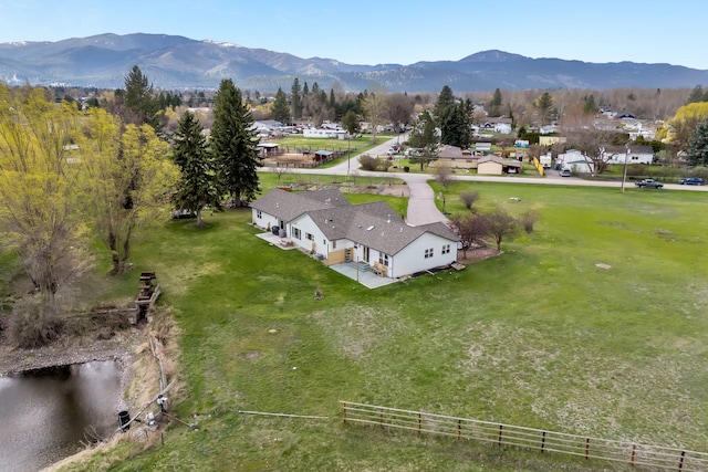 drone / aerial view with a water and mountain view