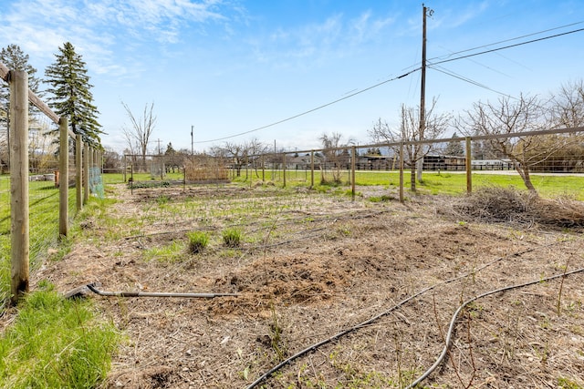 view of yard featuring a rural view and fence