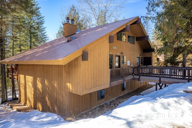 62 Limber Pne, Whitefish, MT 59937 - view of snow covered exterior featuring a chimney, metal roof, and a deck