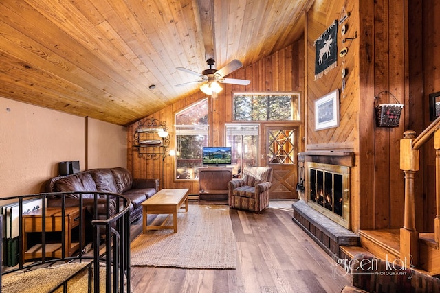62 Limber Pne, Whitefish, MT 59937 - living room featuring vaulted ceiling, hardwood / wood-style flooring, wood ceiling, a ceiling fan, and wooden walls