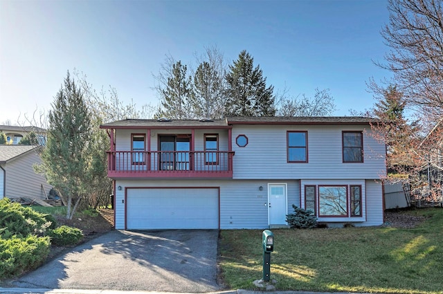 802 Normans Ln, Missoula, MT 59803 - view of front of home with asphalt driveway, an attached garage, a balcony, and a front yard