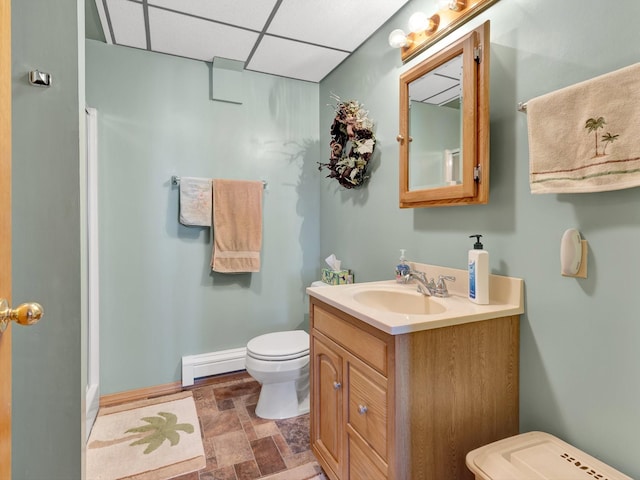 3600 Fairmont Rd, Anaconda, MT 59711 - full bath featuring toilet, baseboards, stone finish flooring, vanity, and a baseboard radiator