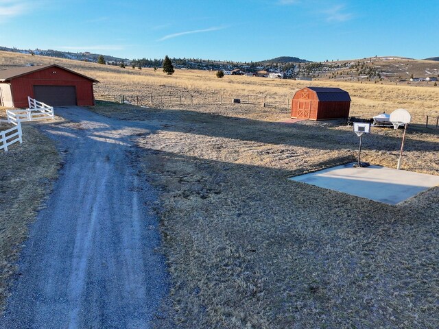 3600 Fairmont Rd, Anaconda, MT 59711 - view of yard with a detached garage, an outbuilding, fence, and a mountain view