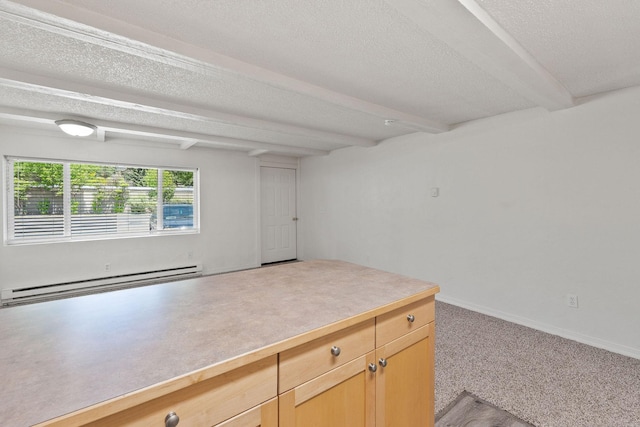 121 Iowa Ave Unit 1G, Whitefish, MT 59937 - spare room featuring a baseboard radiator, beam ceiling, and a textured ceiling