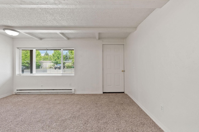 121 Iowa Ave Unit 1G, Whitefish, MT 59937 - carpeted spare room with a baseboard heating unit, a textured ceiling, and beam ceiling