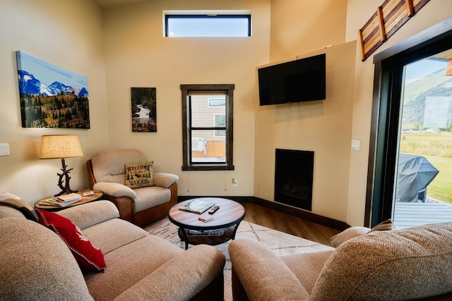 2360 Mt Highway 206, Columbia Falls, MT 59912 - living room featuring plenty of natural light, wood finished floors, a fireplace, and a towering ceiling