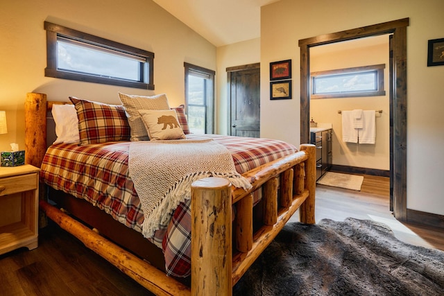 2360 Mt Highway 206, Columbia Falls, MT 59912 - bedroom featuring wood finished floors, lofted ceiling, and ensuite bathroom