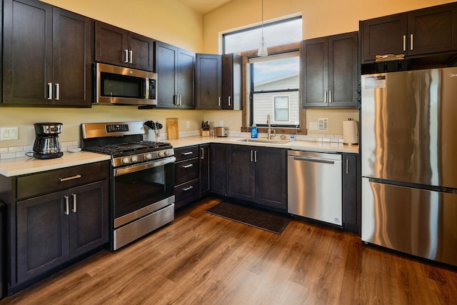 2360 Mt Highway 206, Columbia Falls, MT 59912 - kitchen featuring appliances with stainless steel finishes, light countertops, dark wood-style flooring, and decorative light fixtures