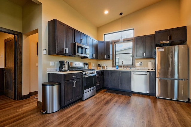 2360 Mt Highway 206, Columbia Falls, MT 59912 - kitchen with appliances with stainless steel finishes, light countertops, dark wood-style floors, high vaulted ceiling, and decorative light fixtures