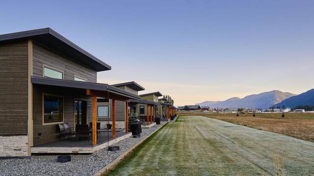 2360 Mt Highway 206, Columbia Falls, MT 59912 - property exterior at dusk with a lawn and a deck with mountain view