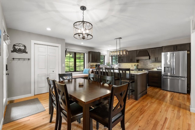 dining area with a chandelier, light wood-type flooring, baseboards, and recessed lighting